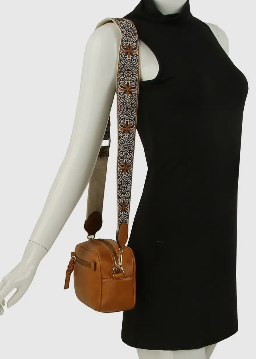Vegan leather boho style  purse with detailed guitar strap. Purse has a zip closure, back zip pocket, gold tone hardware and detachable strap.
8.5 x 5.5 x 3”. Shown in d. brown
