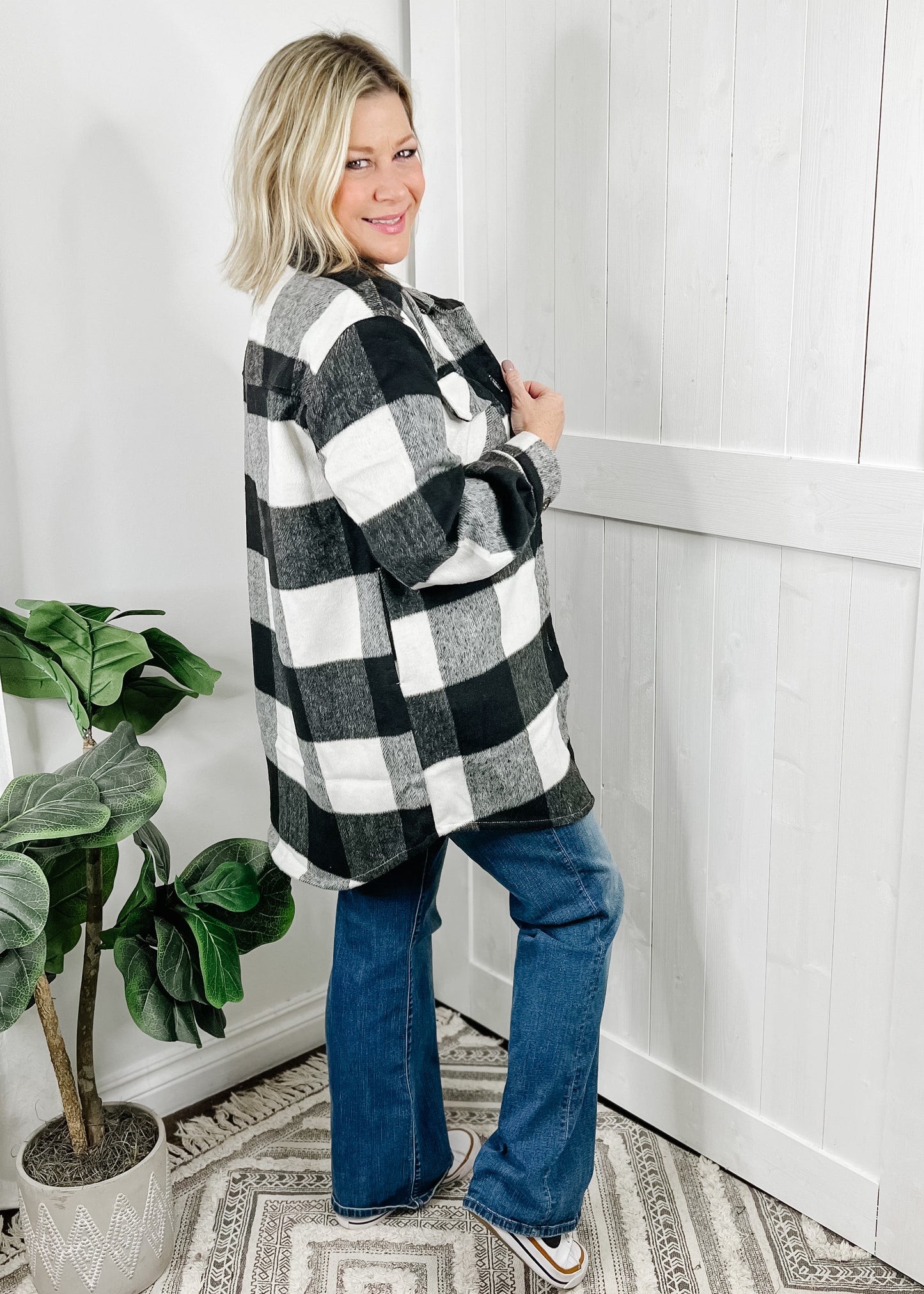Shacket in black and ivory. Shacket details include front button closure, breast pockets, side pockets, collar and button at wrists. This shacket is longer in length, approximately 3 inches above knee on 5.5' model.