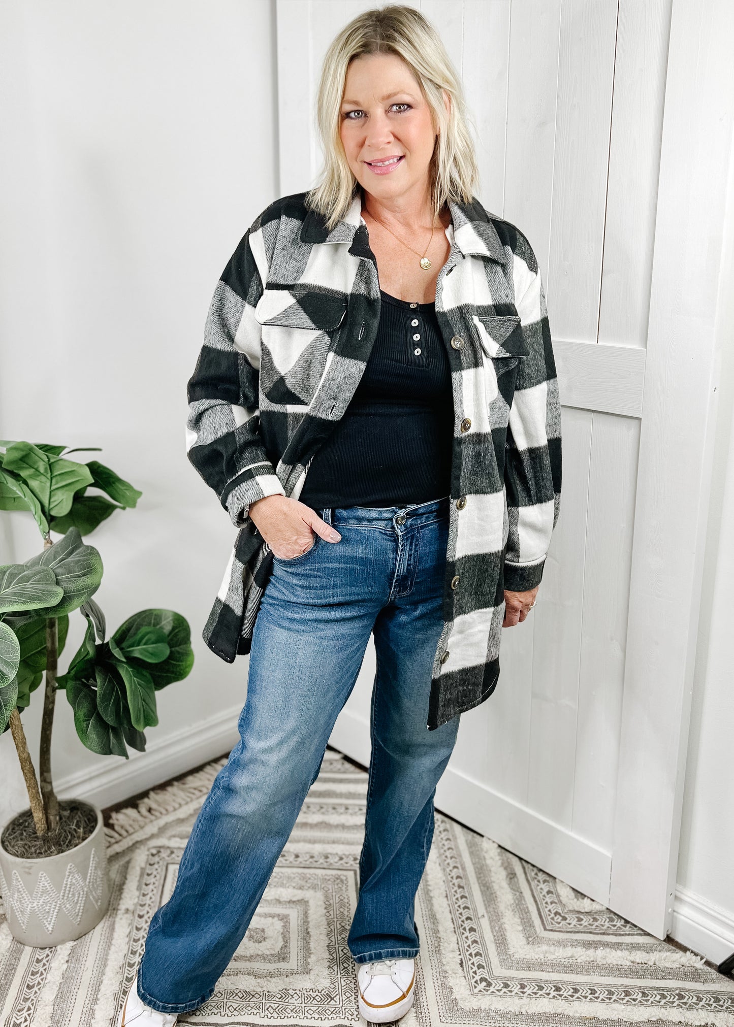 Shacket in black and ivory. Shacket details include front button closure, breast pockets, side pockets, collar and button at wrists. This shacket is longer in length, approximately 3 inches above knee on 5.5' model.