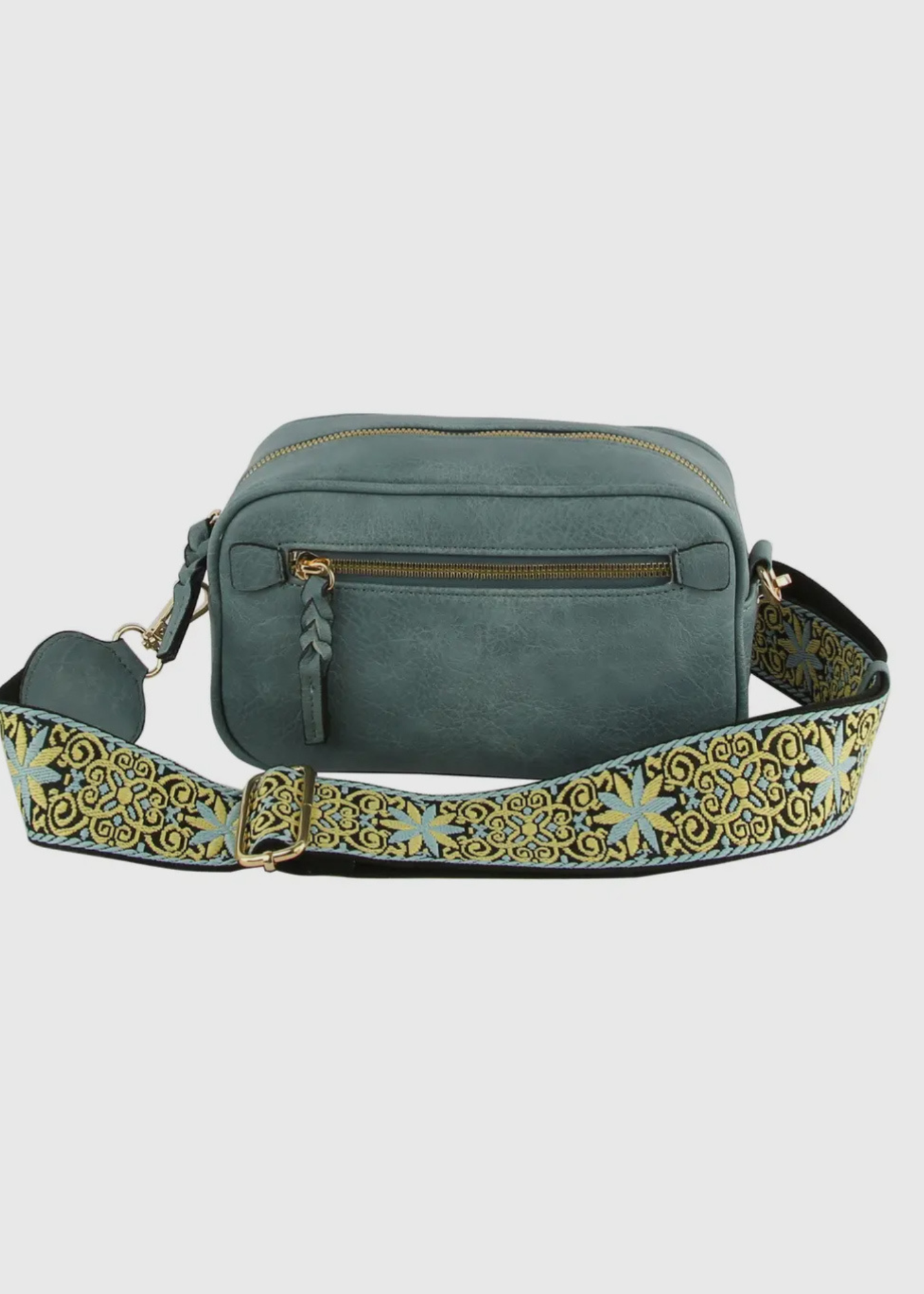 Vegan leather boho style purse with detailed guitar strap. Purse has a zip closure, back zip pocket, gold tone hardware and detachable strap.
8.5 x 5.5 x 3”. Shown in dark teal.