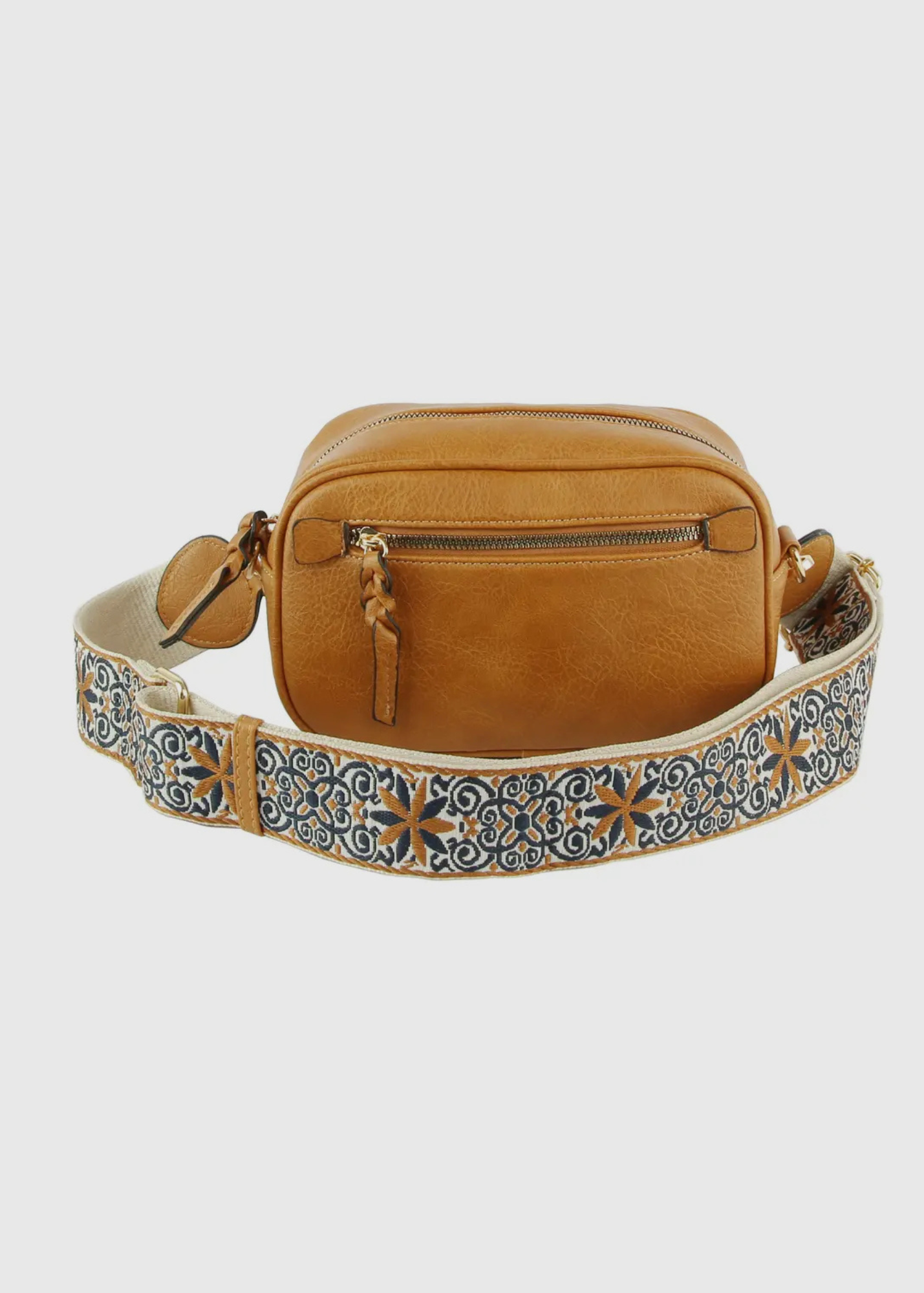 Vegan leather boho style  purse with detailed guitar strap. Purse has a zip closure, back zip pocket, gold tone hardware and detachable strap.
8.5 x 5.5 x 3”. Shown in brown.
