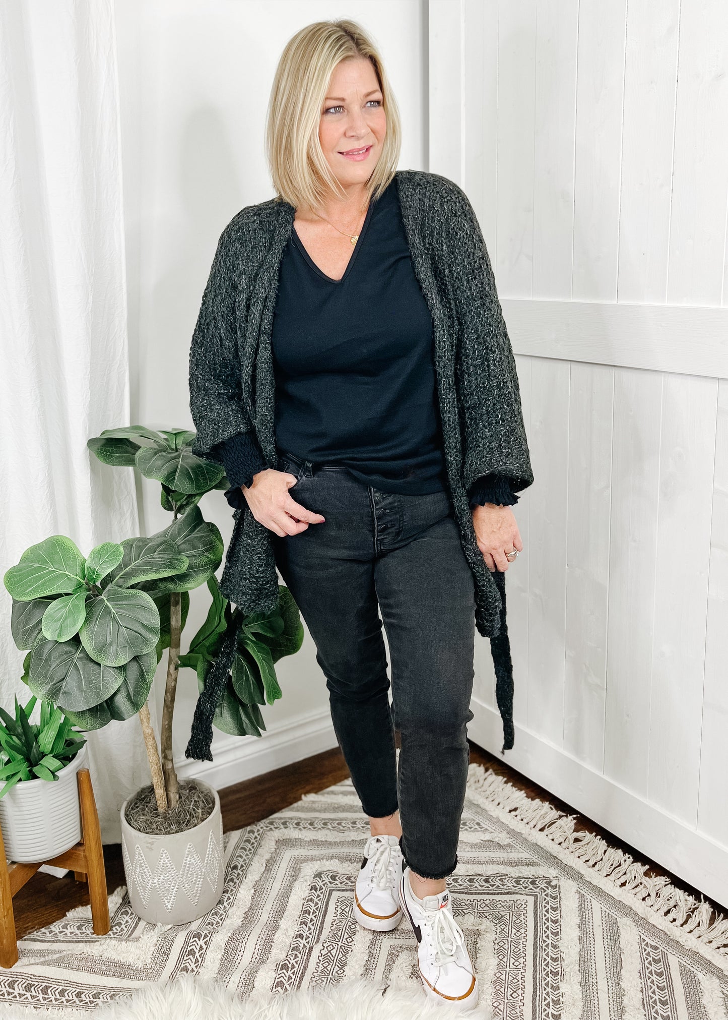 Charcoal knit cardigan with open front and belt for self tie closure. Cardigan has self tie belt, open front, bell sleeves and front pockets.