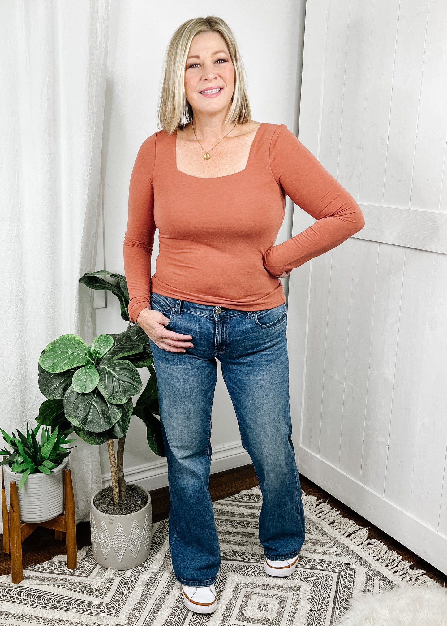 Square neckline top in a pretty terracotta color long sleeve top and smocked back. Fitted style top.