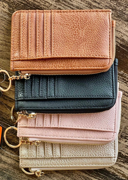 Vegan leather card wallet approximately 5.25 x 3.25. Card holder stores up to 6 cards and features a small zippered coin compartment with keychain ring.