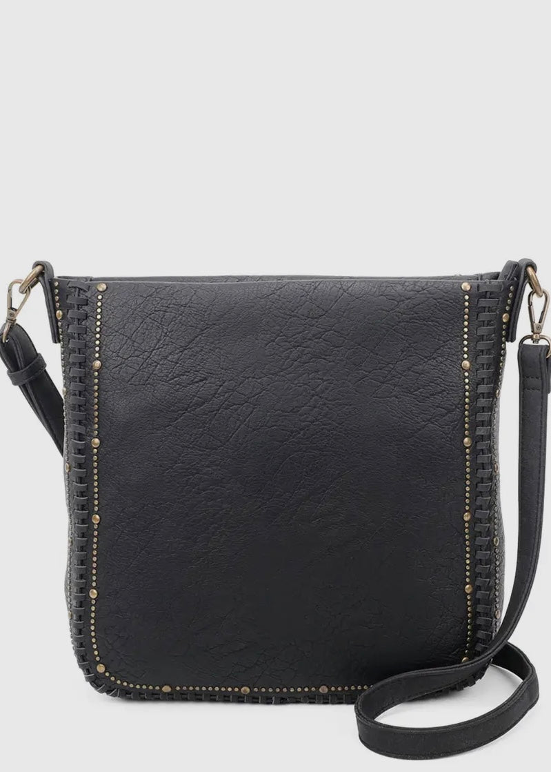 Black vegan leather studded crossbody purse. Purse is 11 x 11 x 4, has gold studded detail around edge, made of a soft vegan leather, top zip closure, back zipper pocket and crossbody strap. Shown in black.