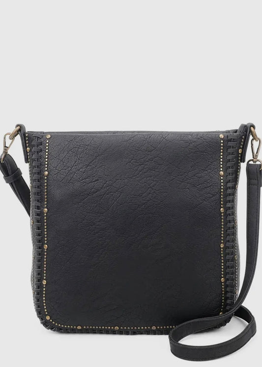 Black vegan leather studded crossbody purse. Purse is 11 x 11 x 4, has gold studded detail around edge, made of a soft vegan leather, top zip closure, back zipper pocket and crossbody strap. Shown in black.