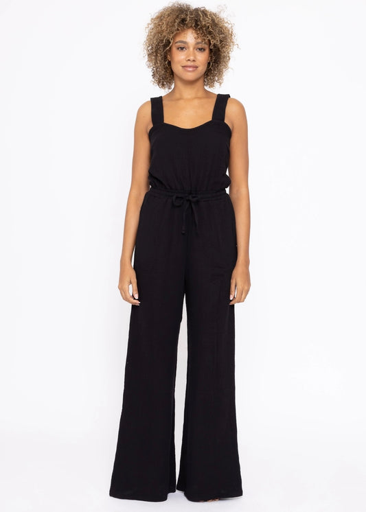 100% cotton Gauze Wide Leg Jumpsuit in black. Features a sweetheart neckline and smocked back panel. Thick 1 1/2 inch straps, side pockets and wide leg.