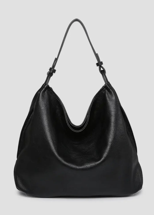 Black vegan leather slouch bag/tote with inner slip and zip pocket and inner zip compartment. Bag has a zipper closure, back zipper pocket and is made of a soft vegan leather. Size: 13x16x5.5