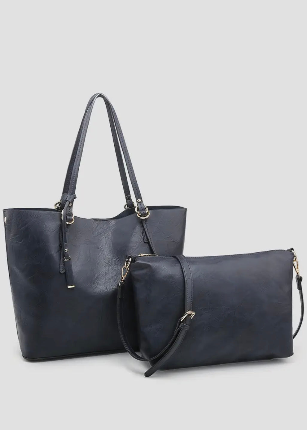 2 in 1 vegan leather tote. 
-Inner Bag: Included with 1 zipper pocket and 2 accessory pockets, herringbone lining
-Straps: Removable adjustable shoulder strap
-Closure: Magnetic snap closure
-Hardware: Gold-tone hardware
-Material: Vegan leather
Shown in black