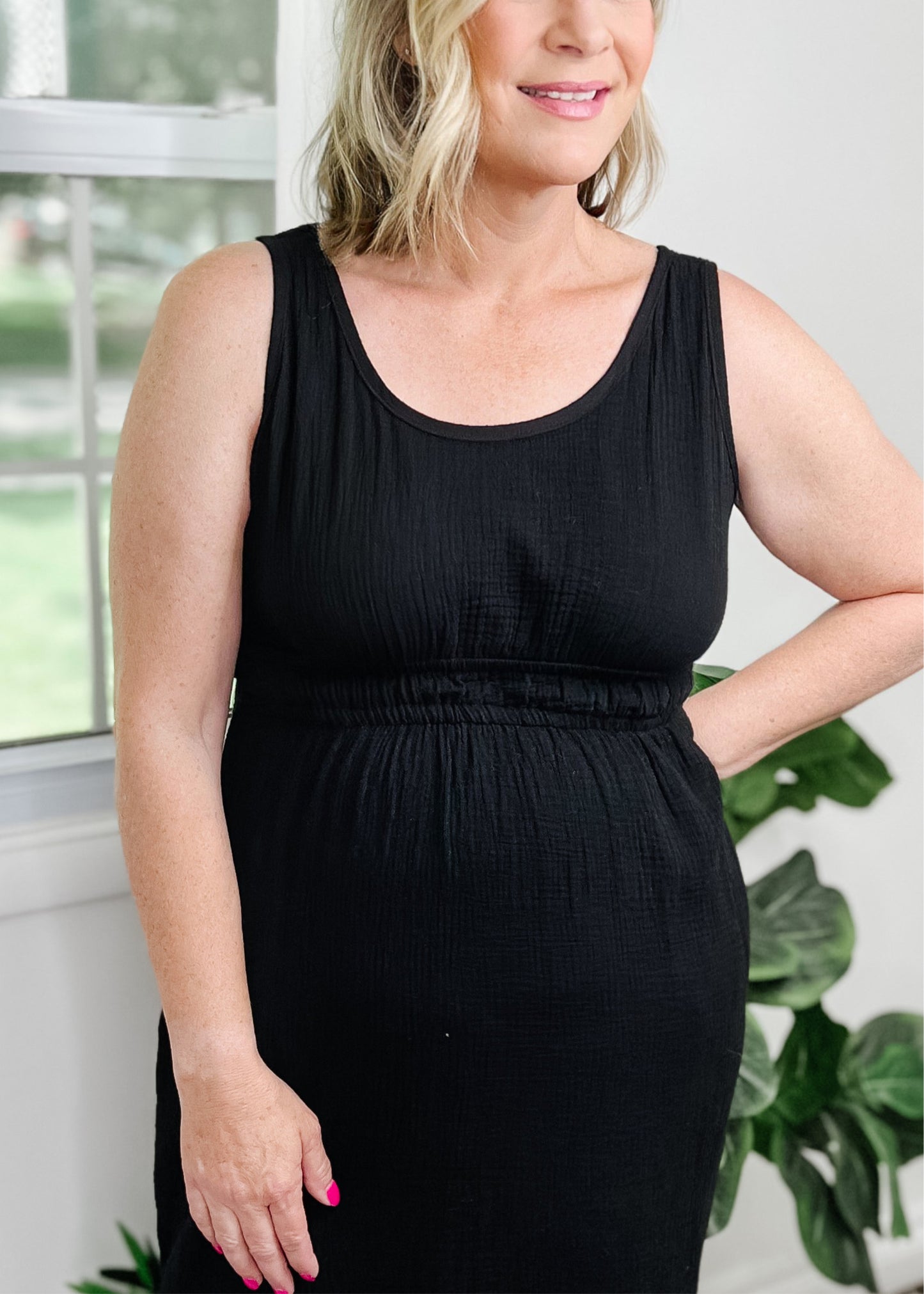 Midi cut out dress black and light gauze fabric. Tank top style sleeves with 2 rows of elastic about an Ince apart for some pretty details. Side slits on bottom curved hemline. Cut out detail is in back above waistline.