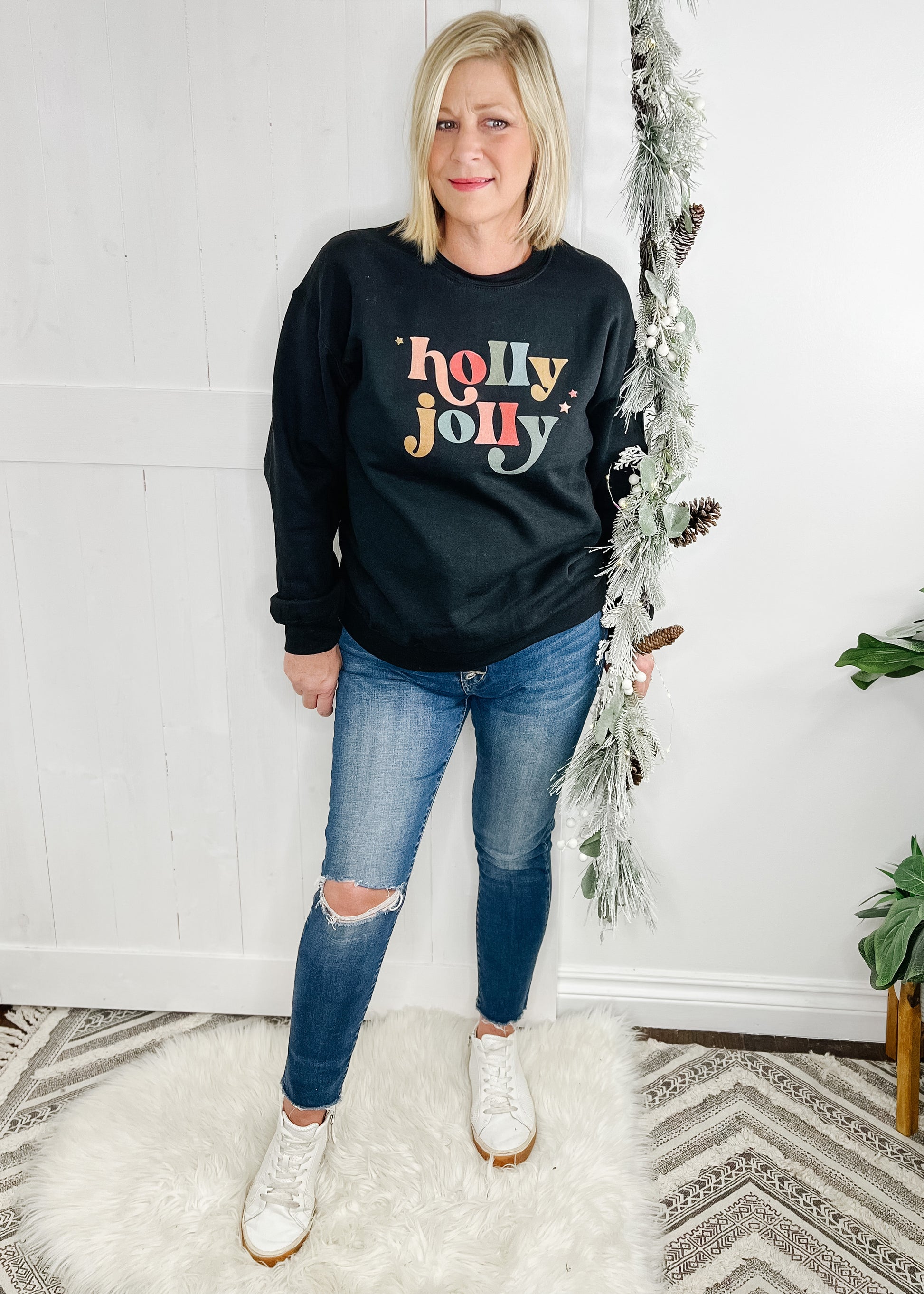 Black Holly Jolly sweatshirt. Holly jolly in multi color with 3 small stars.