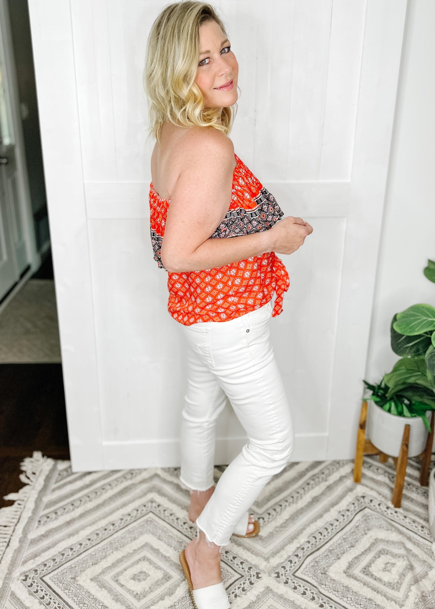 Strapless ruffle top with bandana like print in red with navy details. Features Folder at bust and self tie at Botton center.