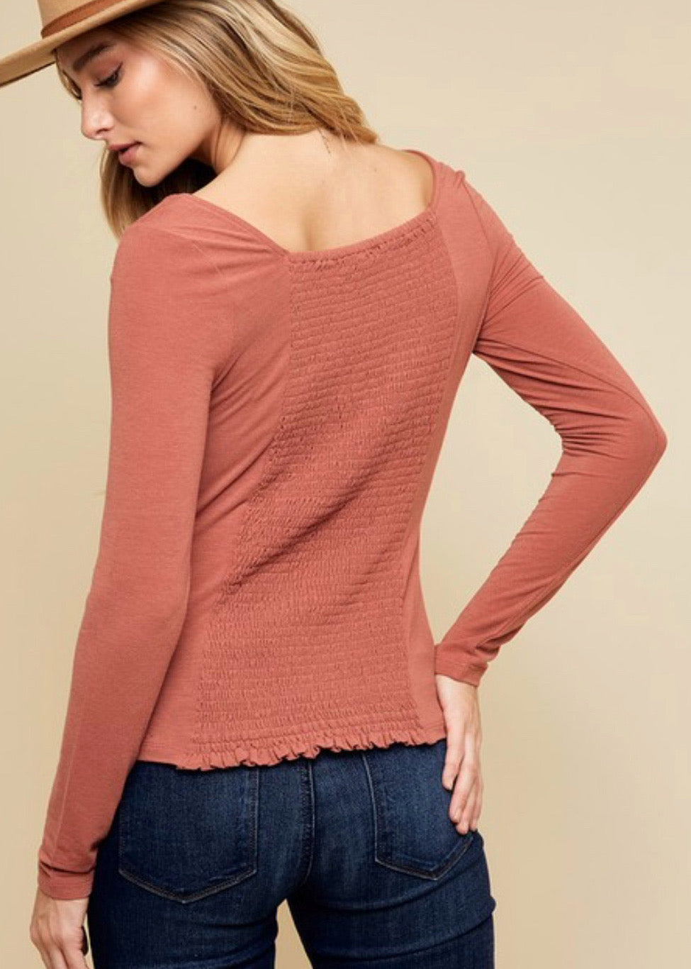 Square neckline top in a pretty terracotta color long sleeve top and smocked back. Fitted style top. 