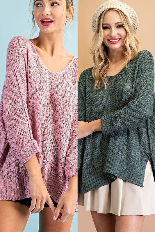 Knit sweater in a pretty mauve color with 3/4 cuffed sleeves, v-neckline and side slits. 