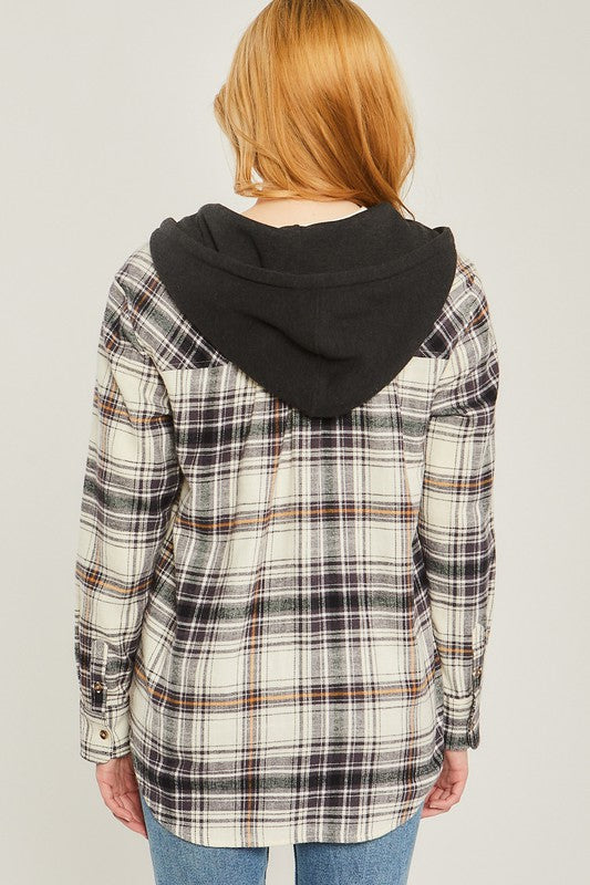 Plaid flannel in cream, black and brown with front button up and pockets. Flannel features a black attached hoodie wit functional drawstrings. 