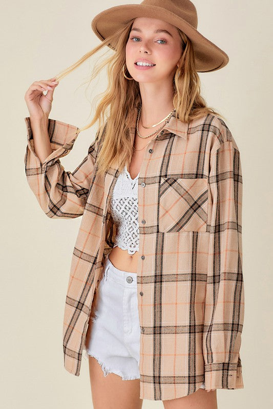 Plaid flannel button up top with front pockets in a light caramel color with black and tan plaid. 