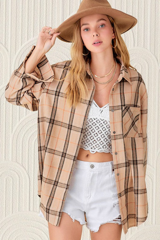 Plaid flannel button up top with front pockets in a light caramel color with black and tan plaid. 