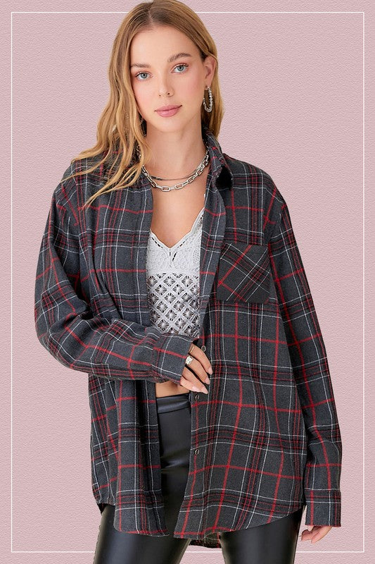 Plaid flannel button up top with front pockets in a dark gray color with black and red plaid. 