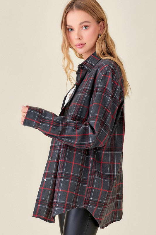 Plaid flannel button up top with front pockets in a dark gray color with black and red plaid. 