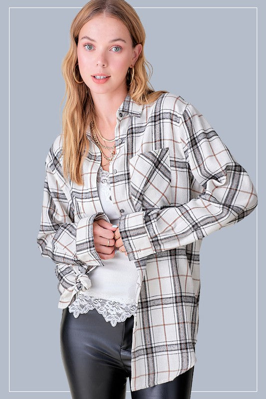 Cream plaid flannel button up top with front pockets in a light bone color with black and tan plaid. 