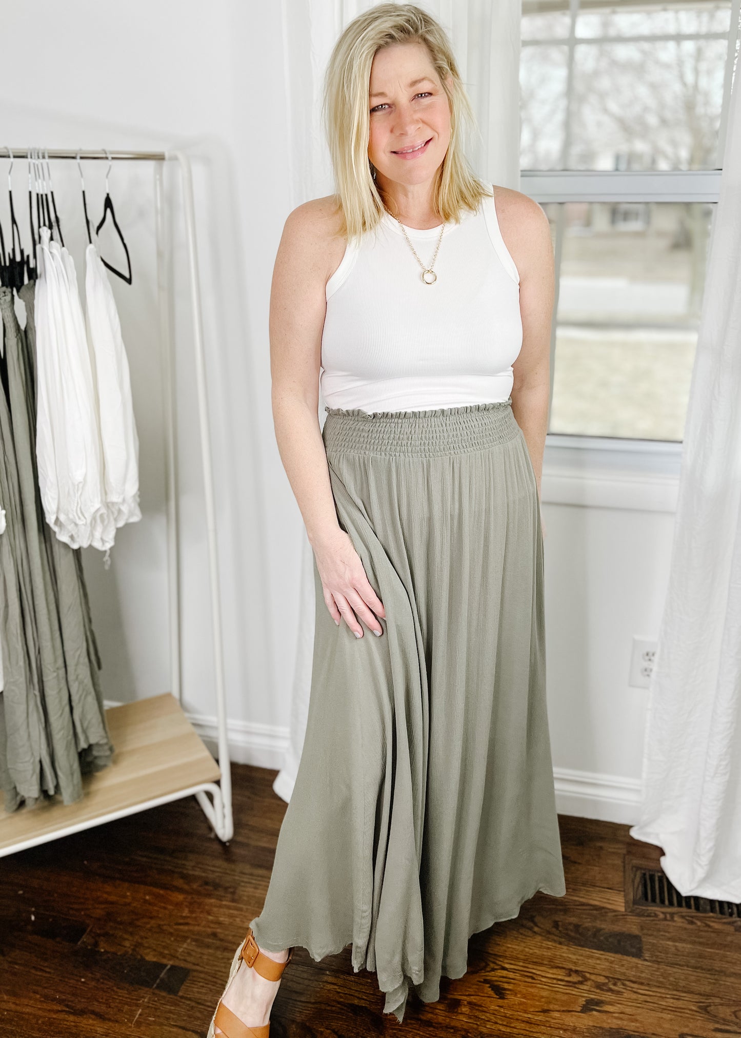 Light olive maxi skirt with a smocked waist, made of lightweight flowy fabric, fully lined  and has side pockets. 