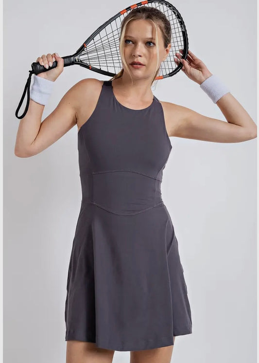 Tennis style dress with thin 1 inch cross straps and key hole back. Built in shirts.  Dress is a buttery soft fabric. 