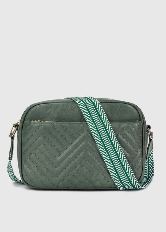 Vegan leather guitar strap purse. Leather is in a chevron pattern, purse has a front slip pocket, zip closure and guitar strap for comfort. Purse is 10 x 7 x 3 and comes in hunter green or brown. 