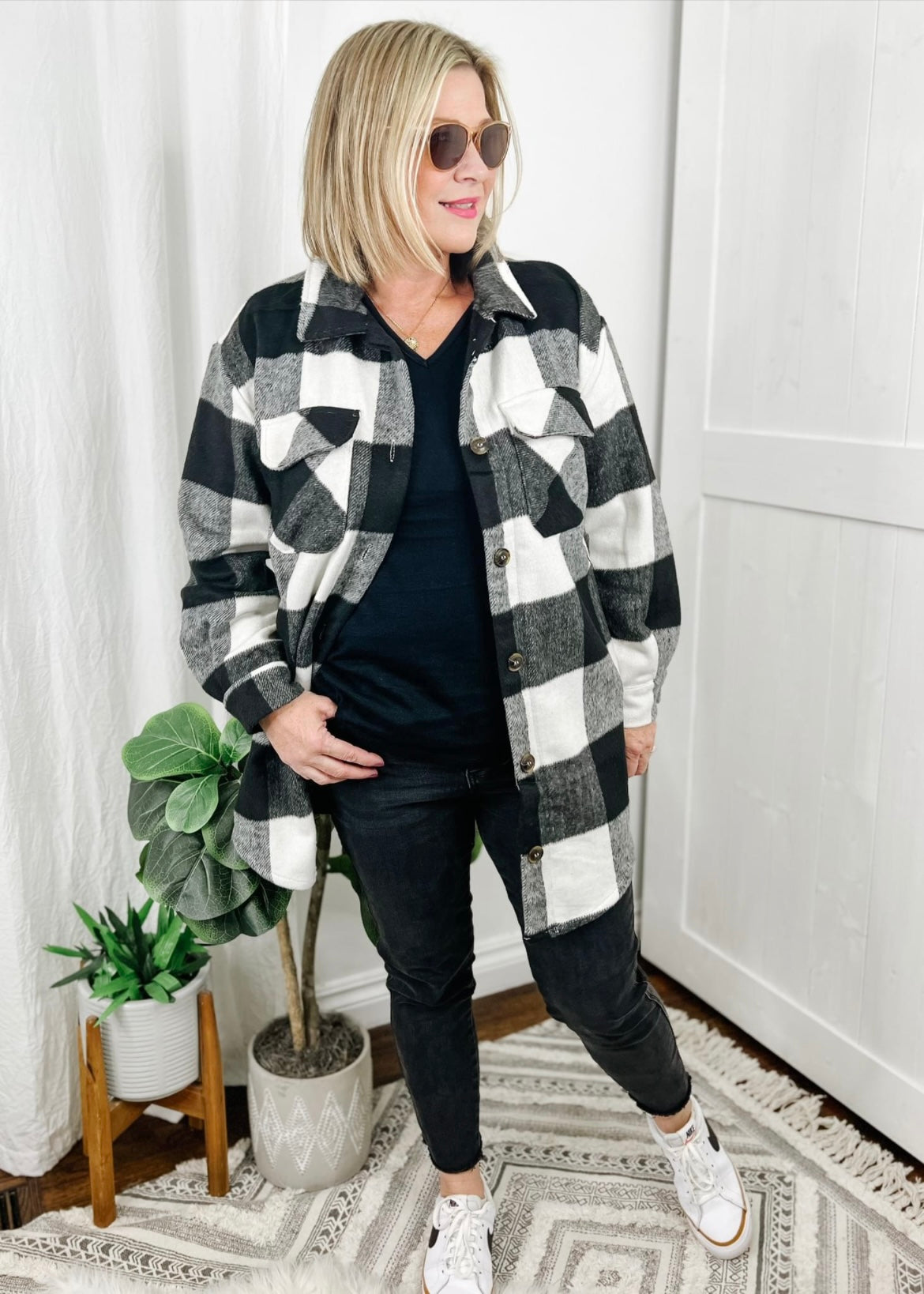 Shacket in a black and white buffalo check print. Shacket has long sleeves, collar, front breast pockets, button closure and slightly longer in length. 