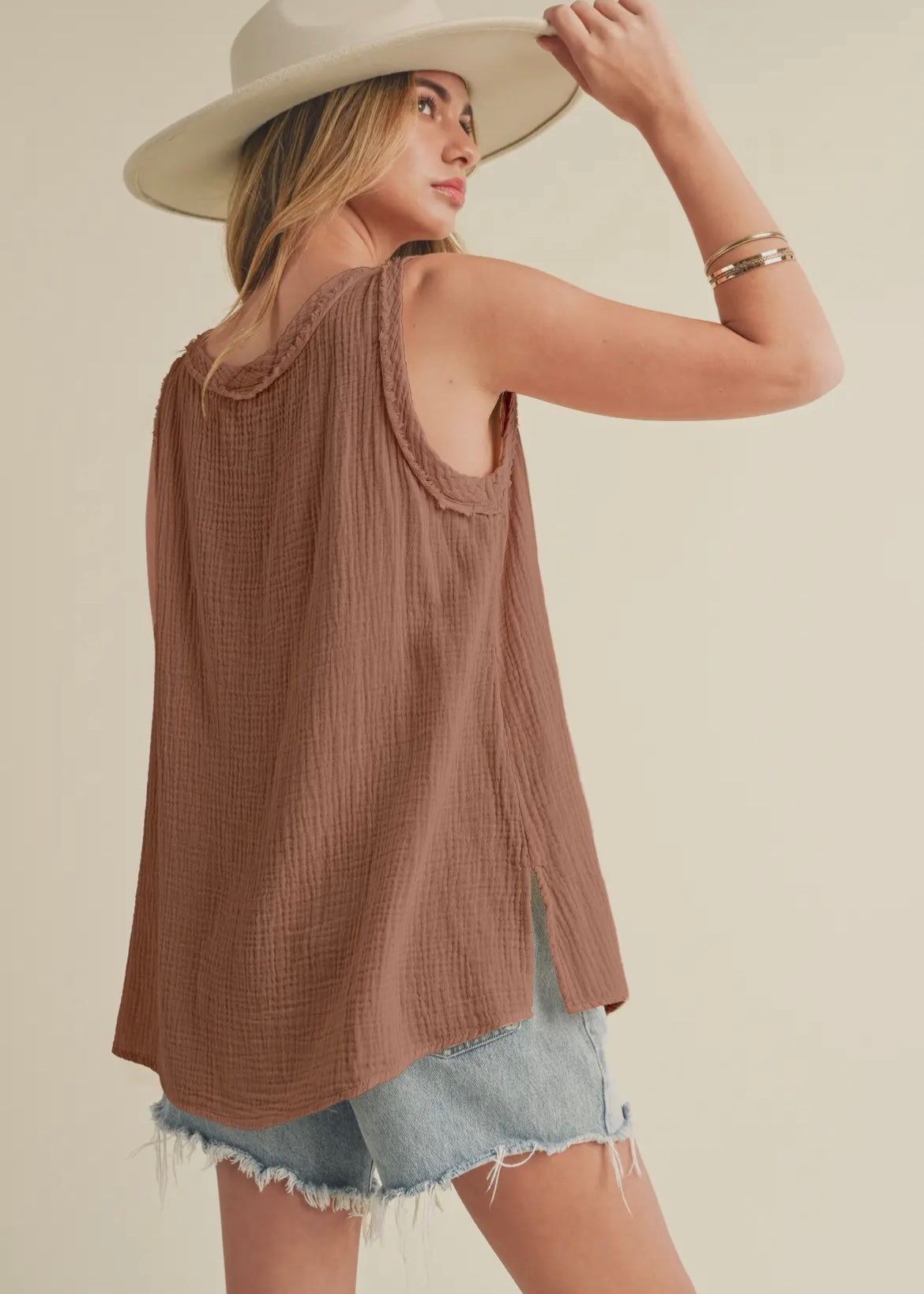 100% cotton gauze tank top with v-neckline and raw hemlines.  