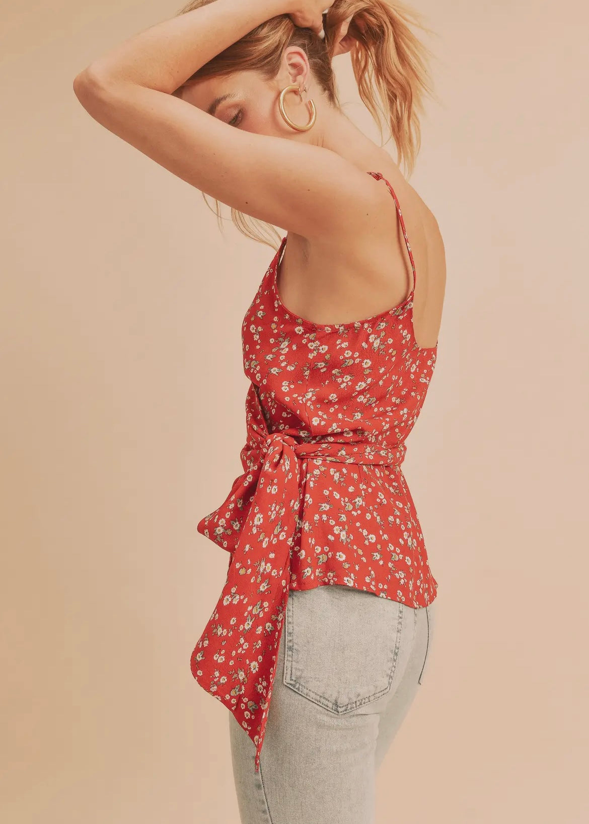 Red floral wrap tank top with thin adjustable straps and crossover front that ties on the side.  