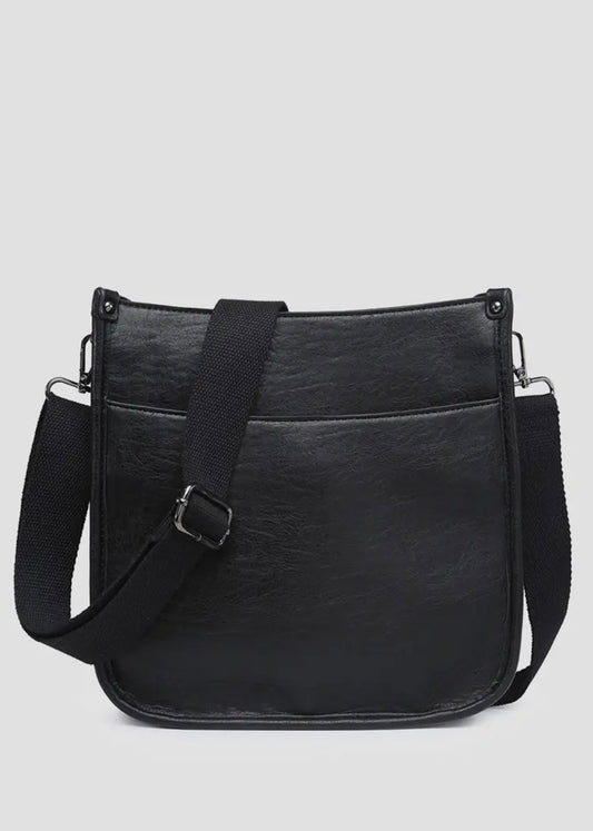 Vegan leather crossbody purse with adjustable black guitar strap. Front has a snap slip pocket, top zip closure to keep your belongings secure.  Dimensions of 10x10x2.5 inches. Shown in black. 