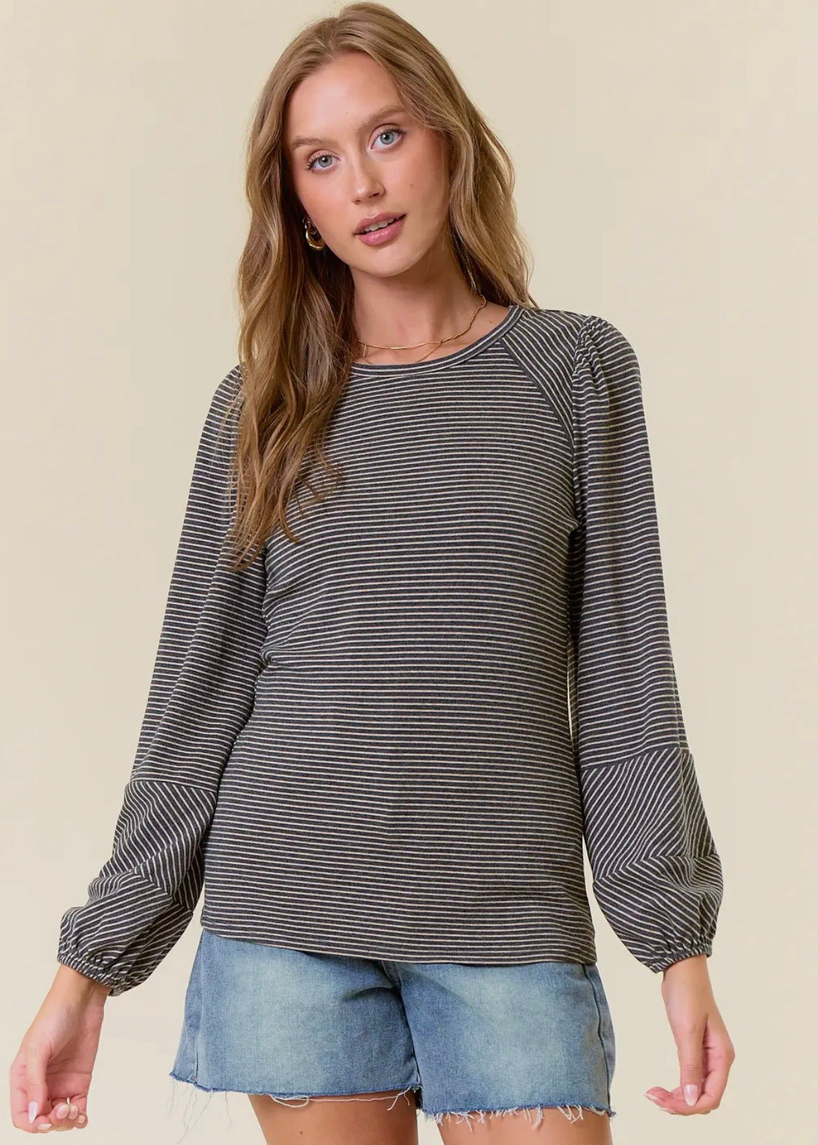 Striped long sleeve top in black and charcoal stripes. Top has balloon sleeves and rounded neckline. Runs true to size. 