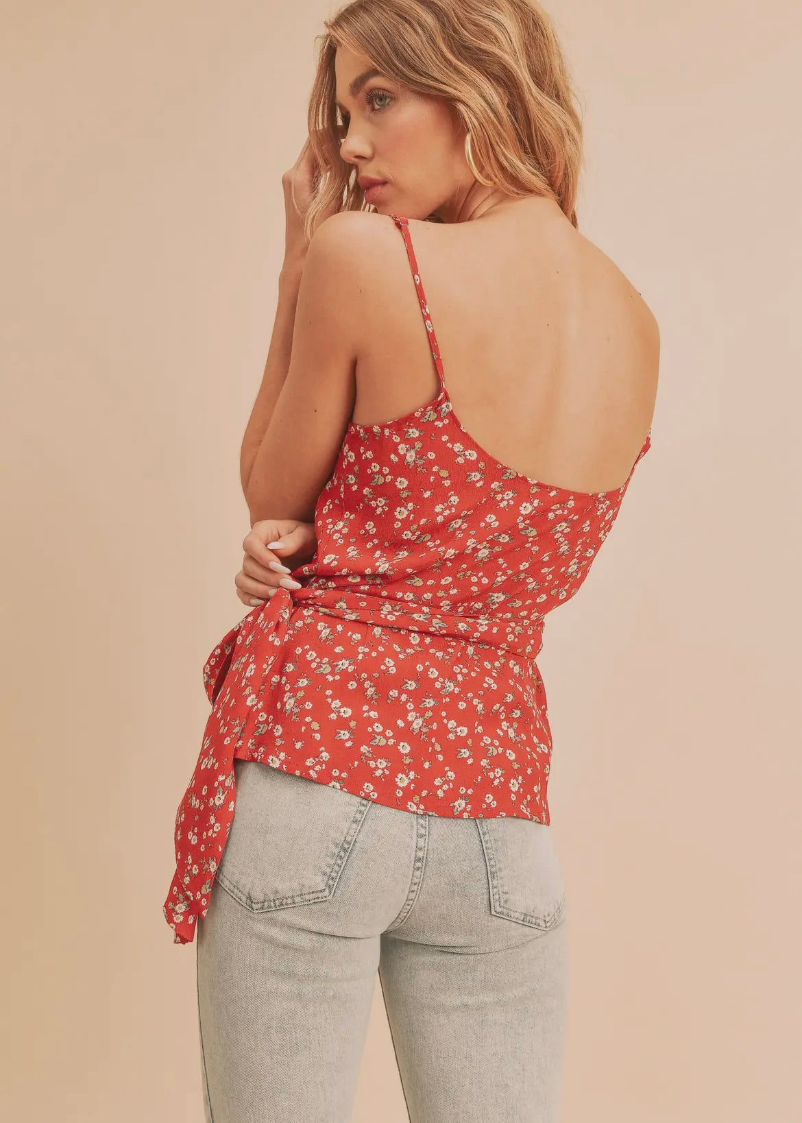 Red floral wrap tank top with thin adjustable straps and crossover front that ties on the side.  