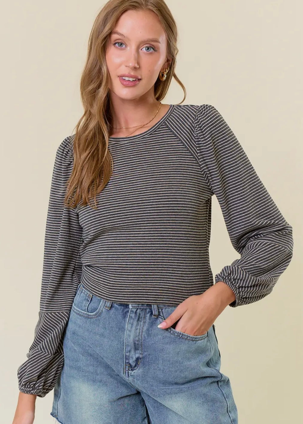 Striped long sleeve top in black and charcoal stripes. Top has balloon sleeves and rounded neckline. Runs true to size. 