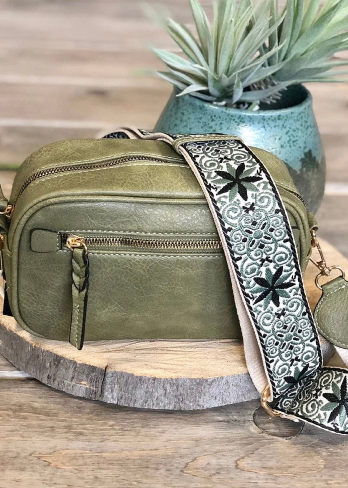 Vegan leather boho style  purse with detailed guitar strap. Purse has a zip closure, back zip pocket, gold tone hardware and detachable strap.
8.5 x 5.5 x 3”. Shown in olive.