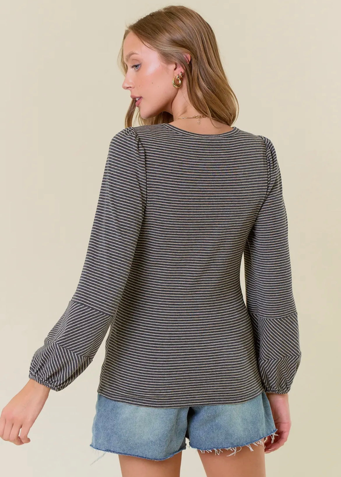 Striped long sleeve top in black and charcoal stripes. Top has balloon sleeves and rounded neckline. Runs true to size. 