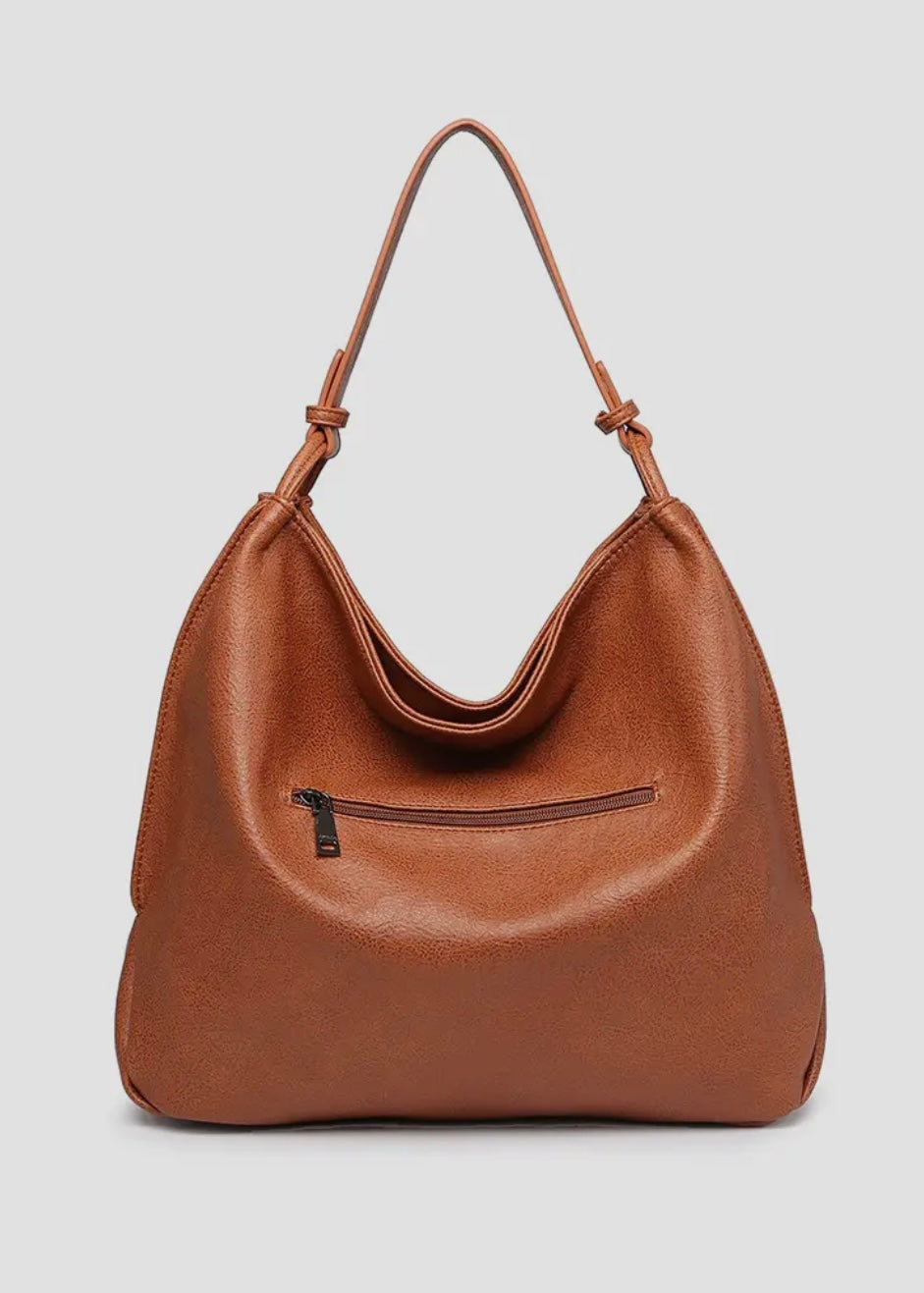 Brown vegan leather slouch bag/tote with inner slip and zip pocket and inner zip compartment. Bag has a zipper closure, back zipper pocket and is made of a soft vegan leather. Size: 13x16x5.5