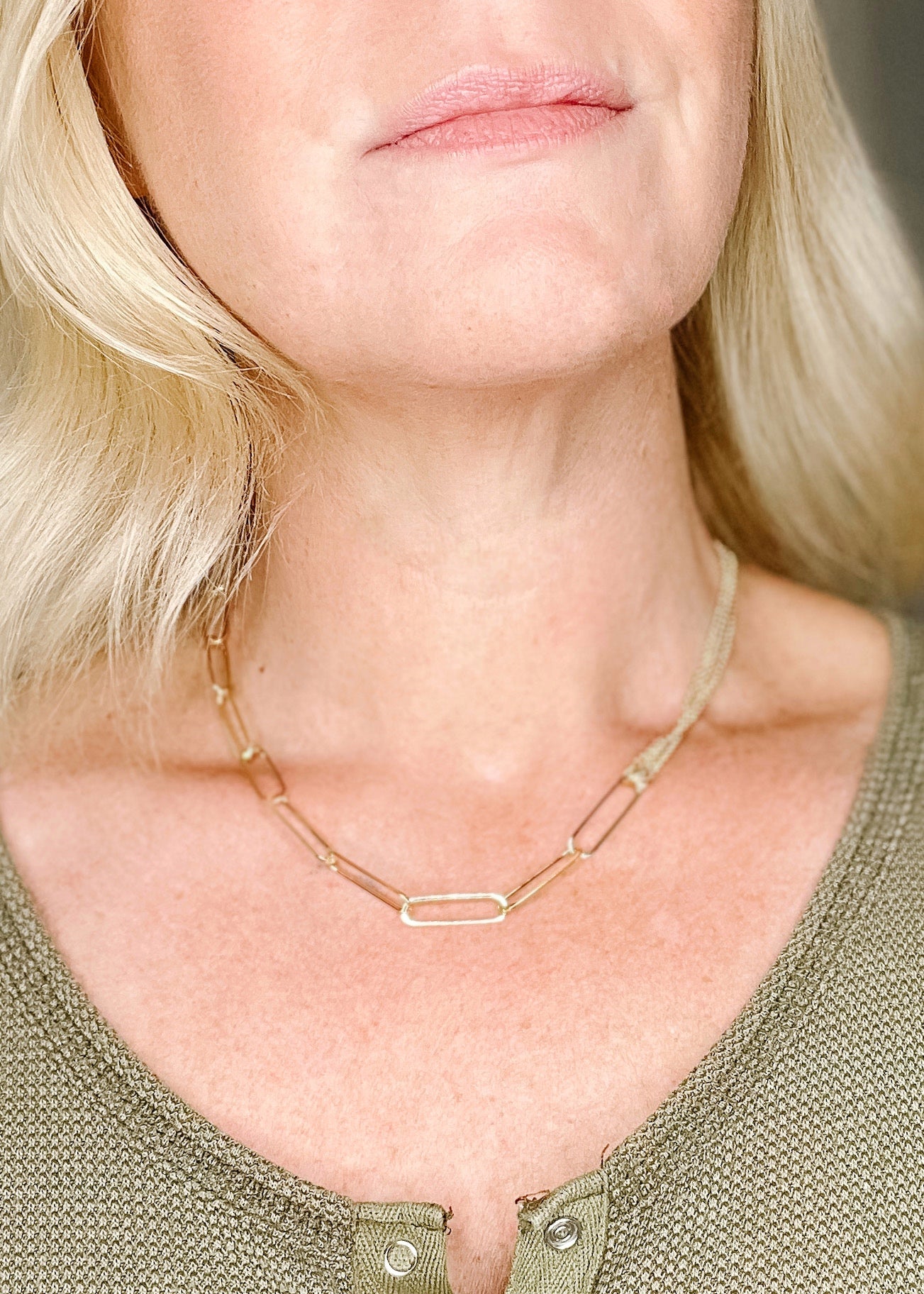 Gold paperclip chain necklace with chain detail. 