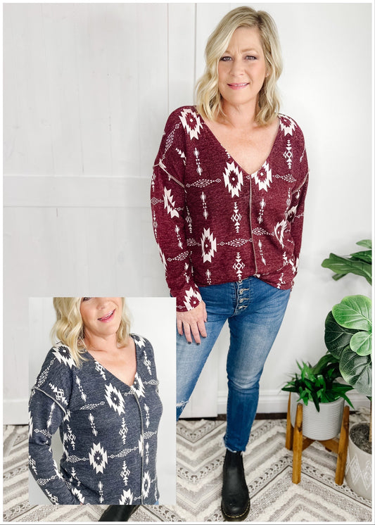 Aztec print top available in Burgundy and Charcoal. Top features, deep v neckline, long sleeves, straight hemline, stitch detail going down front and at shoulder.  Shown with out high rise skinny jeans. 