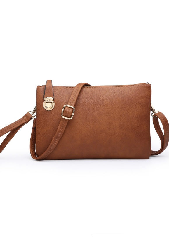 Brown Crossbody/Clutch in a soft vegan leather, top zip closure, gold tone hardware, wrist strap and detachable long shoulder strap (included) and top lock closure. Dimension 12” L x 1” D x 8” H