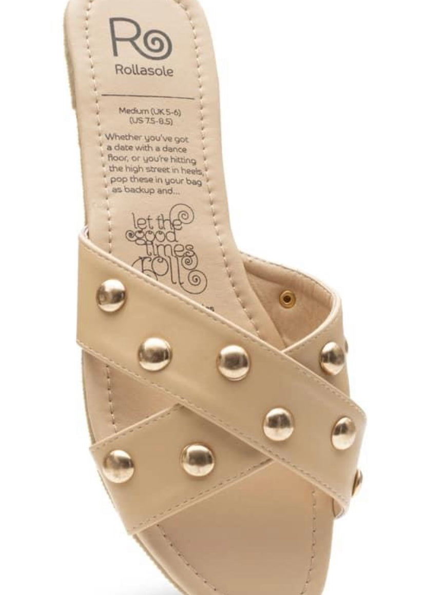 Tan flexible slip on sandals with cross cross design and gold studs.