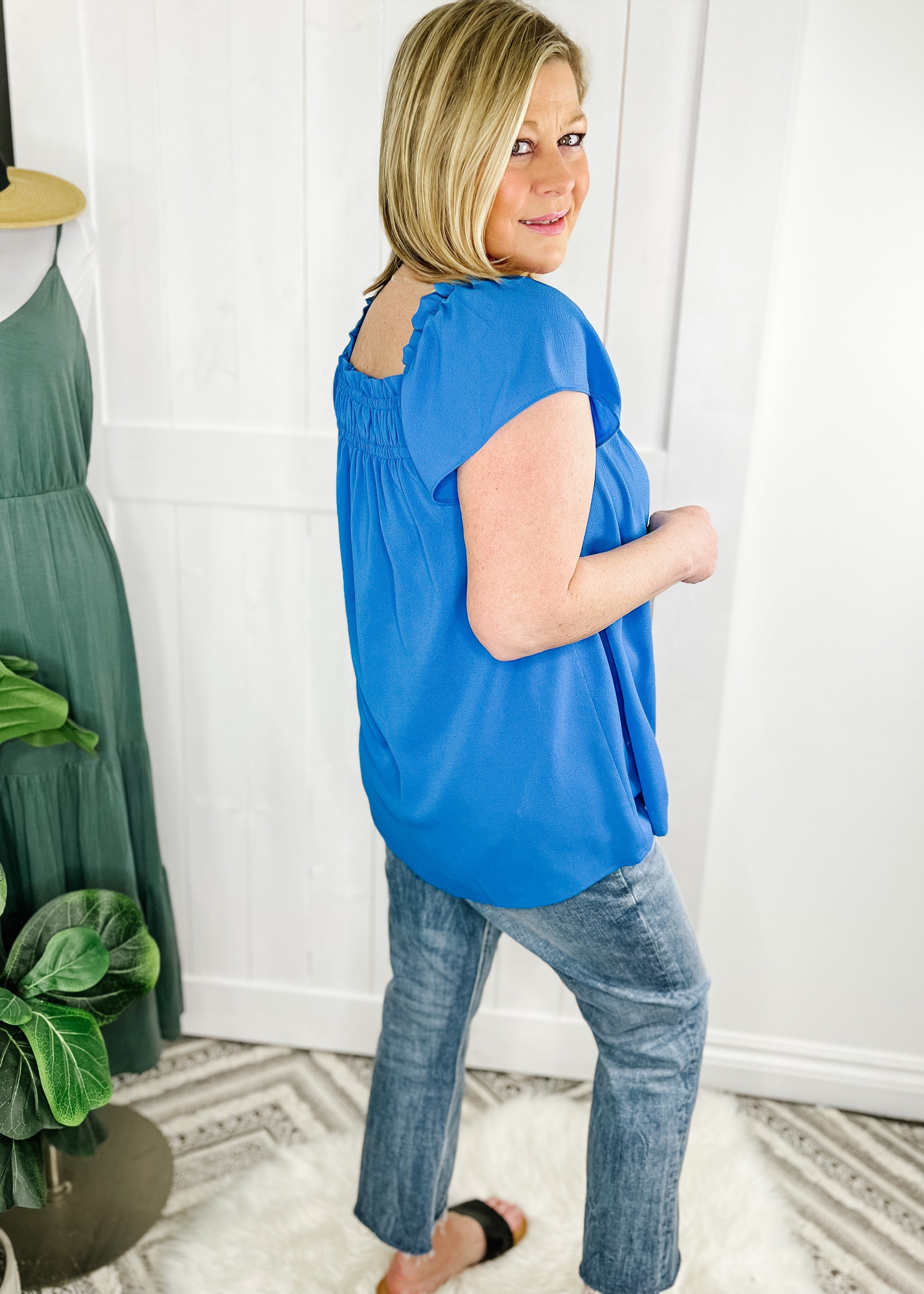 Summer blue short sleeve top with square neckline and cap ruffle like sleeve. 