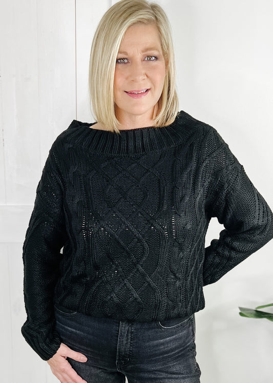 black off the shoulder cable knit sweater with long sleeves. 