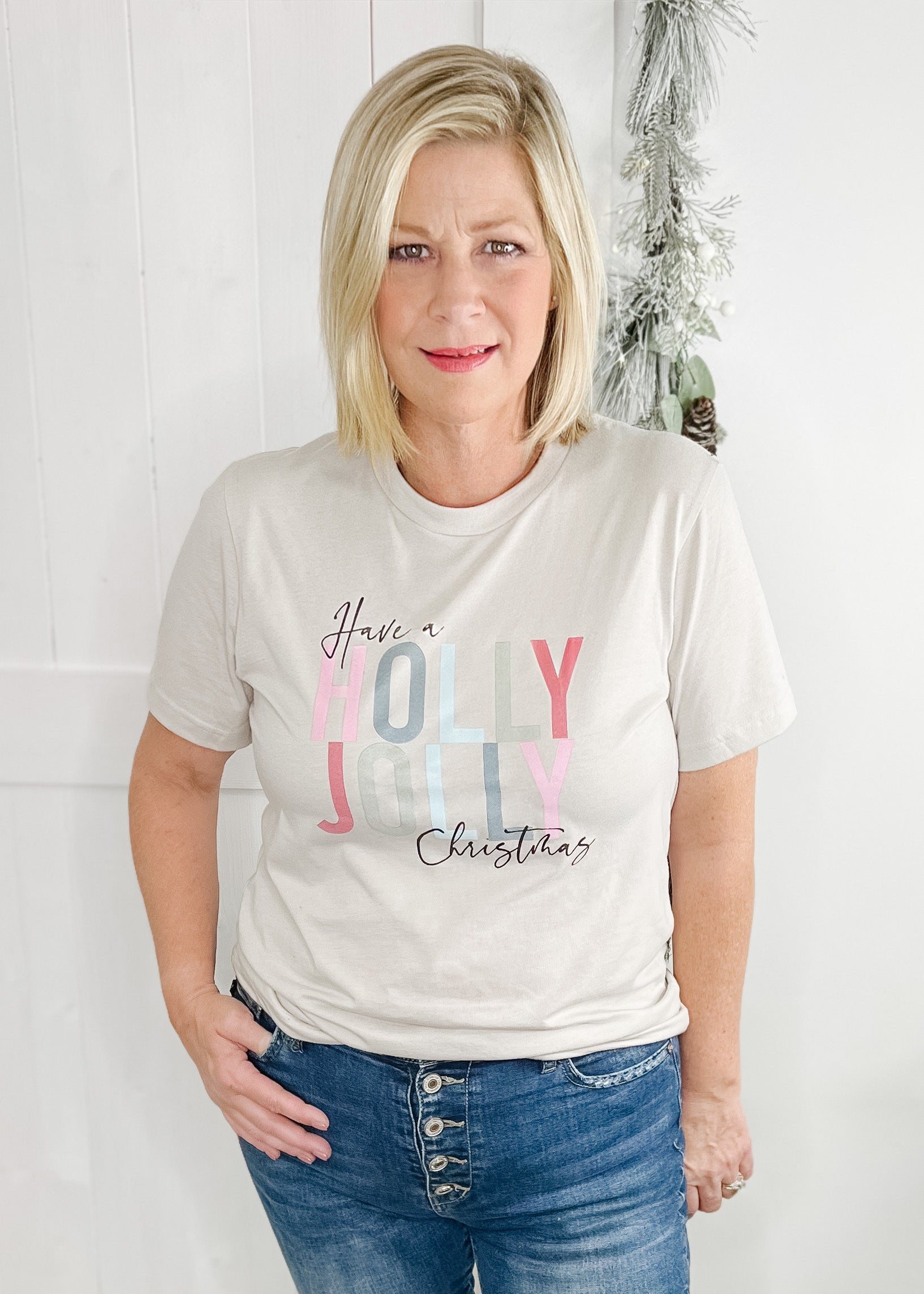 Cream Have a Holly Jolly Christmas tee. holly Jolly in multi pastel colors and have a Christmas is in black. 