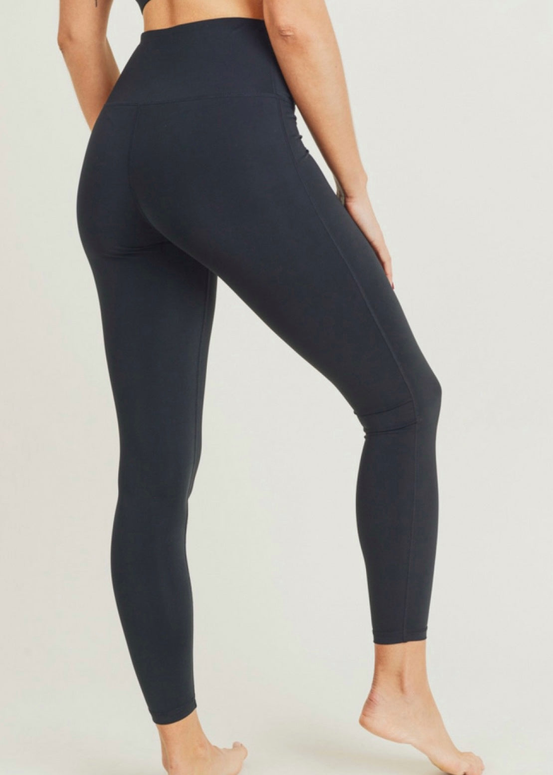 Black Performance leggings made out of 100% recycled nylon and Lycra blend. Leggings have high waist, discreet pouch on waistband, moisture wicking and four way stretch. 